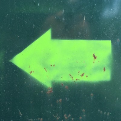 day-glo green arrow painted on dumpster, Pittsburgh, PA