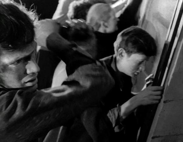 still from the movie "Night of the Living Dead" showing zombies breaking into farmhouse