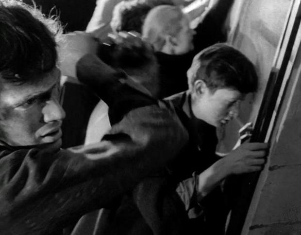 still from the movie "Night of the Living Dead" showing zombies breaking into farmhouse