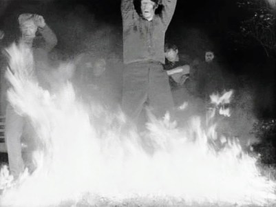 still from "Night of the Living Dead" with zombies recoiling from fire