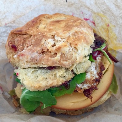 Egg biscuit with Gouda cheese, bacon, arugula, jalapeño peppers, and marionberry jam