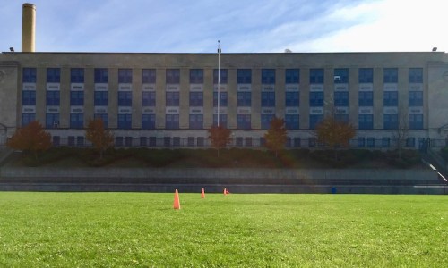 Arsenal Middle School in Pittsburgh PA with a large green playing in front.