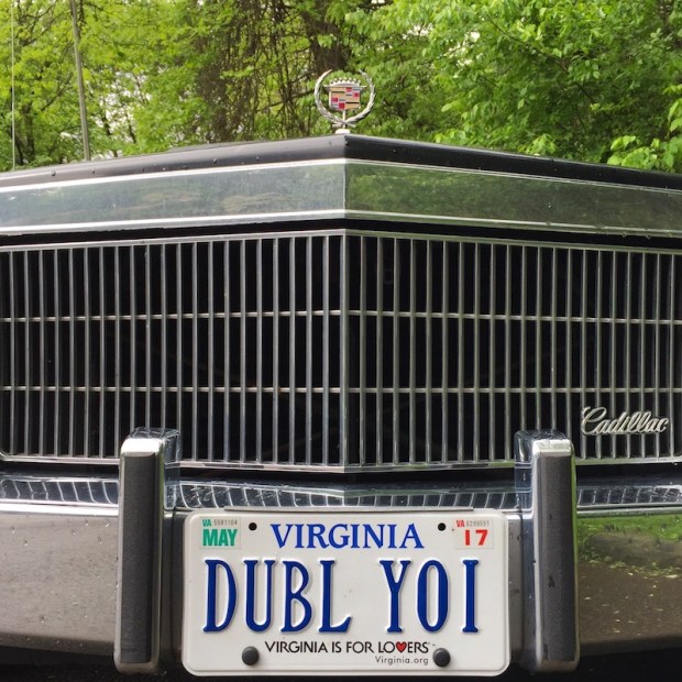 front grill of a 1970's Cadillac with "DUBL YOI" Virginia license plate