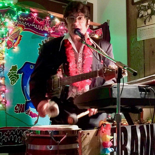 entertainer Frankie Capri in Elvis-style dress with electric guitar, keyboard, and conga drum
