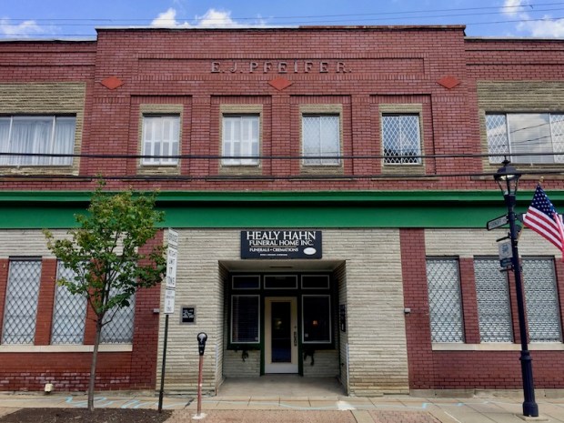 blue line painted on sidewalk in front of Healy Hahn Funeral Home, Millvale, PA