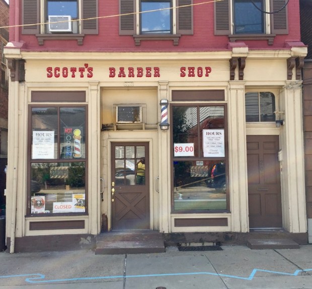 blue line painted on sidewalk in front of Scott's Barber Shop, Millvale, PA