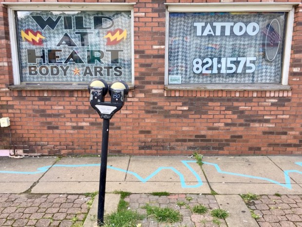 blue line painted in front of Wild at Heart Body Arts, Millvale, PA