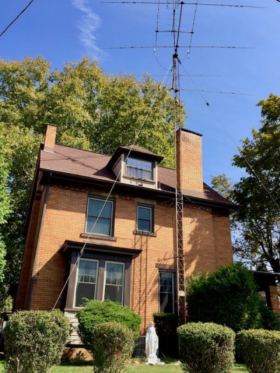 Mary statuette in front of house with large aerial antenna, New Brighton, PA