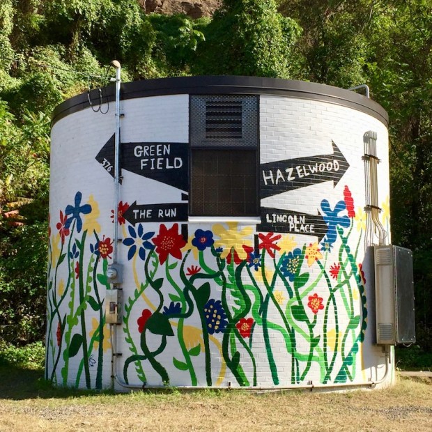 mural with directions pointing to Pittsburgh neighborhoods Greenfield, Hazelwood, The Run, and Lincoln Place
