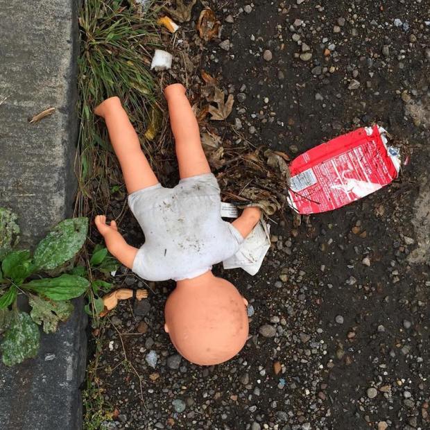 baby doll laying face down on street, Pittsburgh, PA