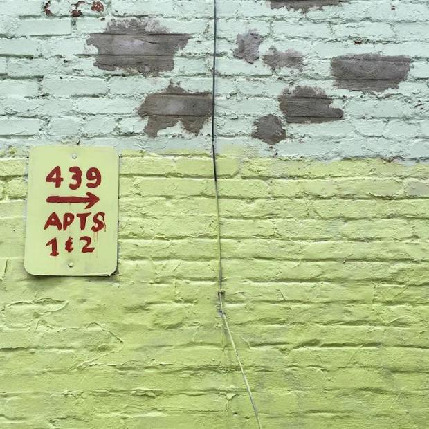 brick wall painted green and aqua with homemade address sign, Pittsburgh, PA