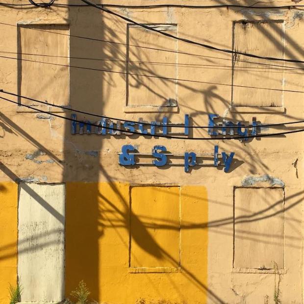 facade of building with shadows of telephone pole and wires, Pittsburgh, PA