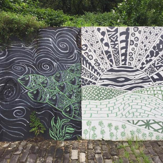 mural on outside retaining wall of fish and sunset, Penn Hills, PA