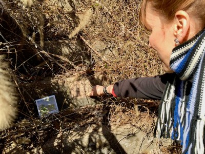 woman marking public steps with sidewalk chalk