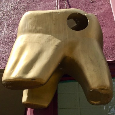 large plastic tooth painted gold hanging in front of dentist's office, Pittsburgh, PA