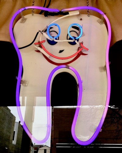 neon sign of large tooth with smiley face advertising dentist, Ambridge, PA