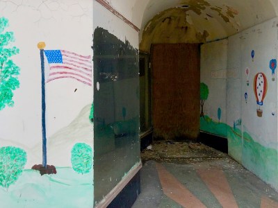 abandoned storefront with American flag painted on glass, Ambridge, PA