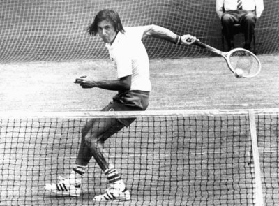 tennis player Ille Nastase hitting a ball behind his back