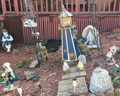front yard covered with decorative figurines, lighthouse, and Mary statuette, Donora, PA