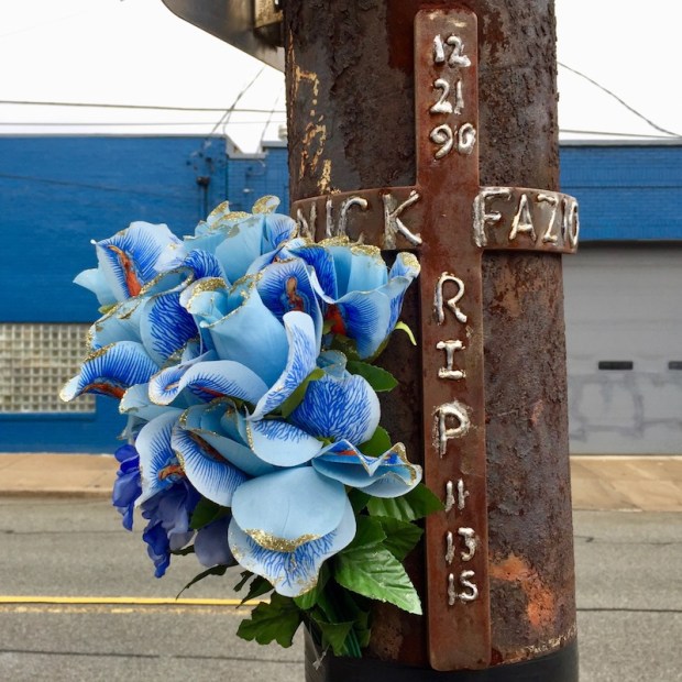 iron memorial cross with plastic flowers on utility pole, Pittsburgh, PA
