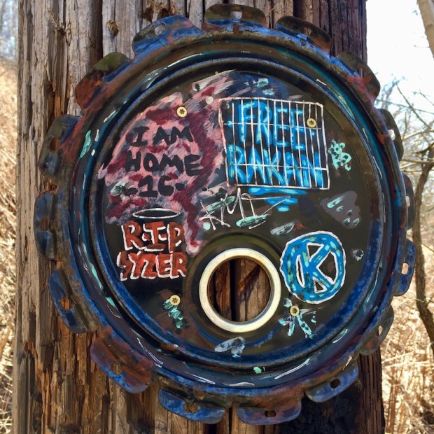 steel can lid painted and attached to utility pole, Pittsburgh, PA
