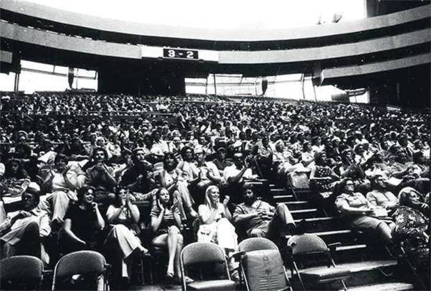 large seated crowd watching tennis match