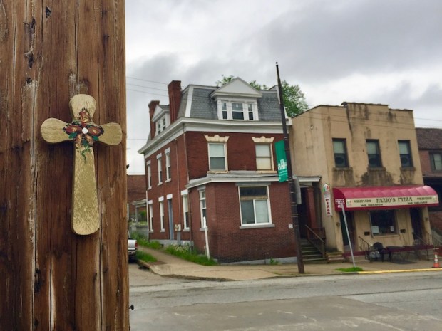 wooden cross attached to utility pole, Pittsburgh
