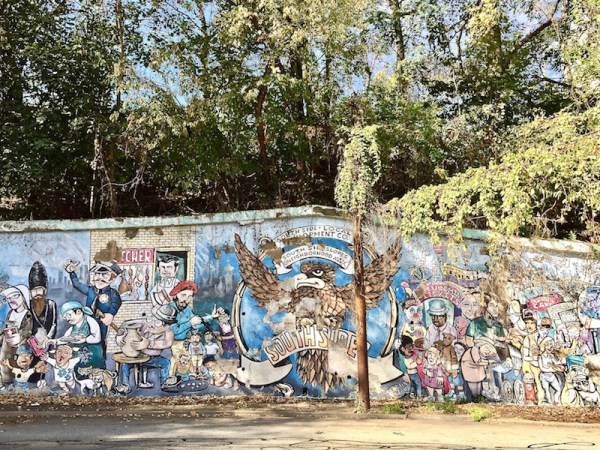 mural on retaining wall showing various neighborhood people in Southside, Pitttsburgh, PA