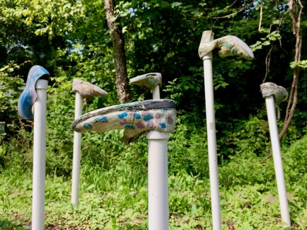 shoes attached to PVC pipe staked in the ground