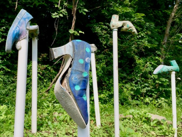 shoes attached to PVC pipe staked in the ground