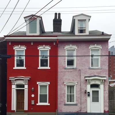 matched pair of row houses painted red and pink, Pittsburgh, PA