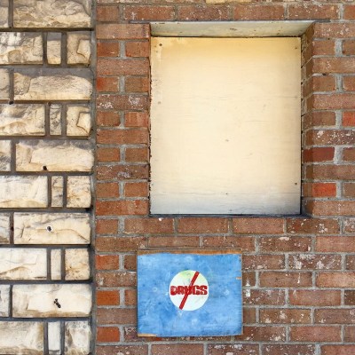 brick wall with handmade "no drugs" painting on wood, Clairton, PA