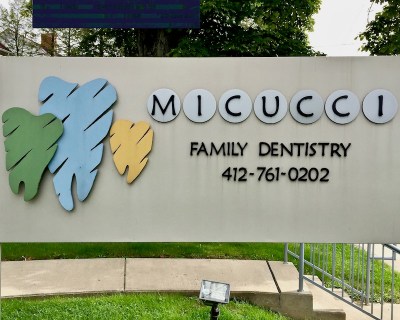 dentist sign with stylized teeth in multiple colors, Bellevue, PA