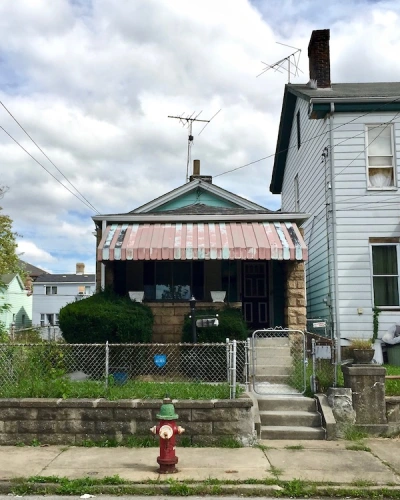 small house with tin awning and green paint, Pittsburgh, PA