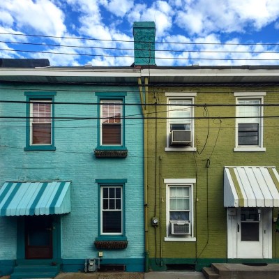 pair of brick row houses painted aqua blue and olive green, Pittsburgh, PA