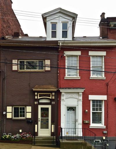 pair of matching row houses with many exterior alterations, Pittsburgh, PA