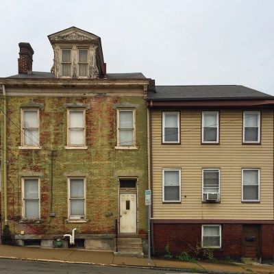 side-by-side brick and frame row houses in Pittsburgh, PA