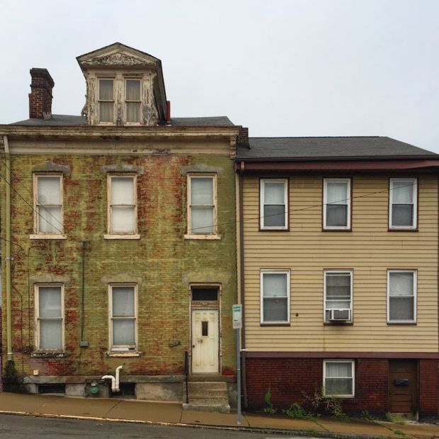 side-by-side brick and frame row houses in Pittsburgh, PA