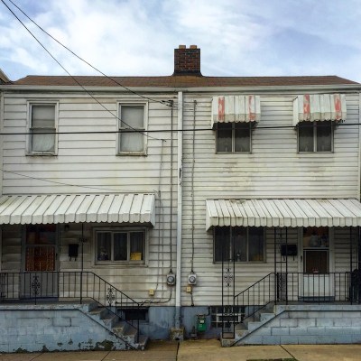 side-by-side row houses with dingy aluminum siding, Pittsburgh, PA