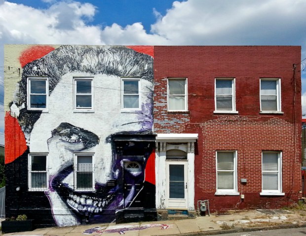 identical brick row houses, one with elaborate mural across the entire front, Pittsburgh, PA