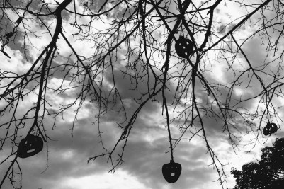 wooden Jack-o-lantern ornaments hanging from bare tree limbs