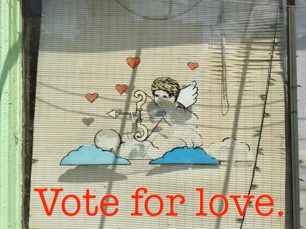 Storefront window with faded image of cupid, Clairton, PA