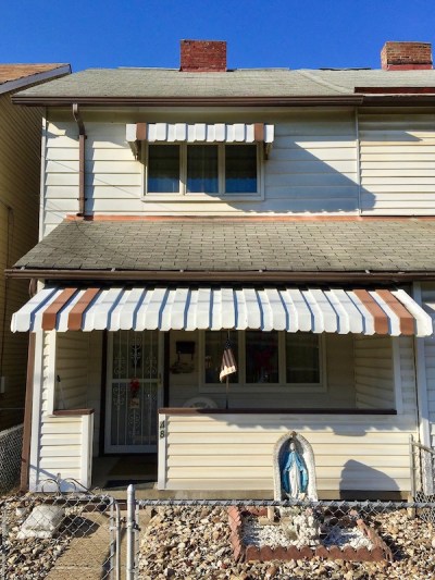 statuette of Mary in front yard of row house, McKees Rocks, PA