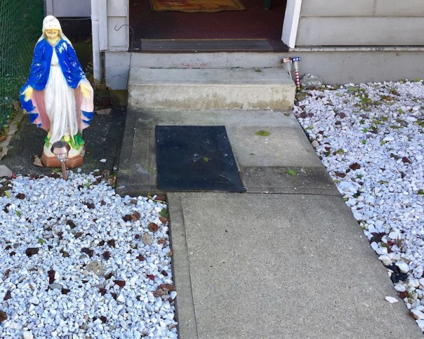 statuette of Mary in gravel front yard of row house, McKees Rocks, PA