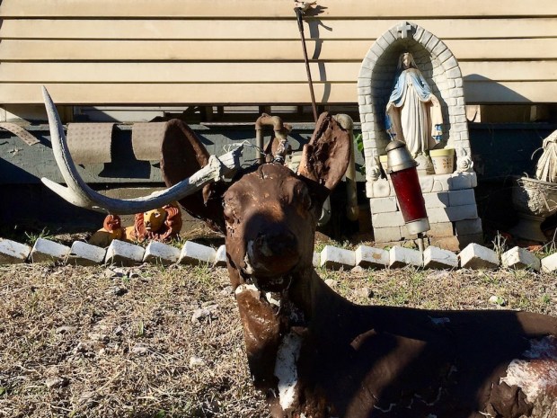 statuette of Mary with deer statue in front yard of row house, McKees Rocks, PA