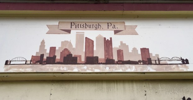painting of Pittsburgh skyline on retail storefront