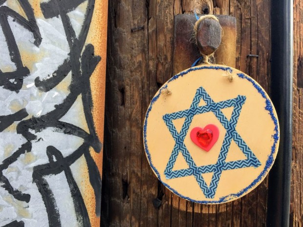 wooden disc with Star of David hanging on utility pole, Pittsburgh, PA