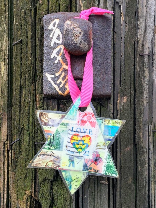 Star of David made from postage stamps hanging on utility pole, Pittsburgh, PA