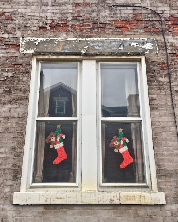 windows decorated with Christmas stockings, Pittsburgh, PA