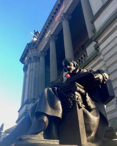 statue of William Shakespeare with plastic apple added